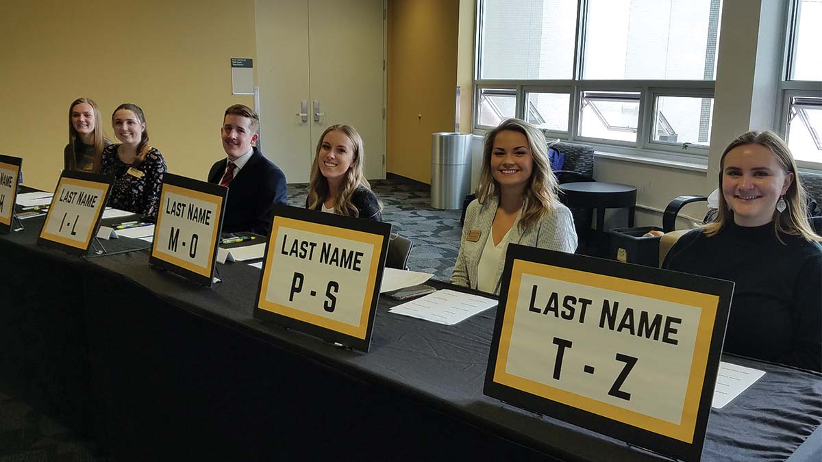 Interns at Etiquette Dinner check-in