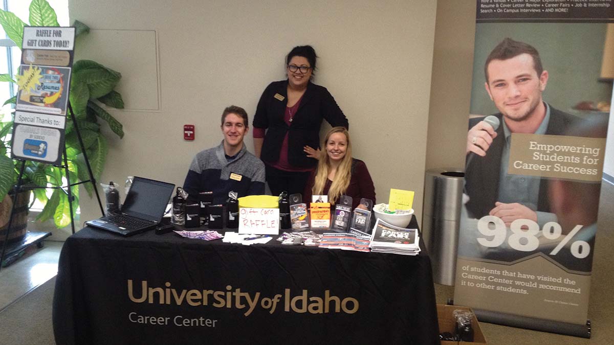 Interns at the 'Drive By Resume' and gift card raffle table in the ISUB