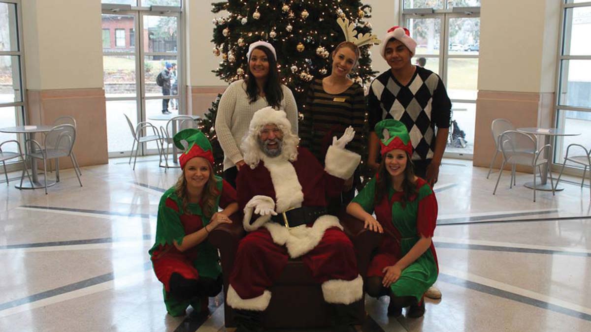 Several interns including a few dressed as elves at the Free Photos with Santa event