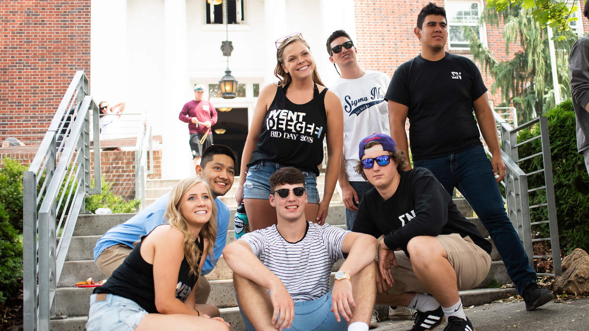 Greek students in front of a house