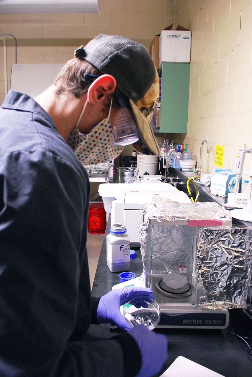 Travis Lindsay mixes a saltwater solution that will contain the polymers known to resist bacteria on Earth.