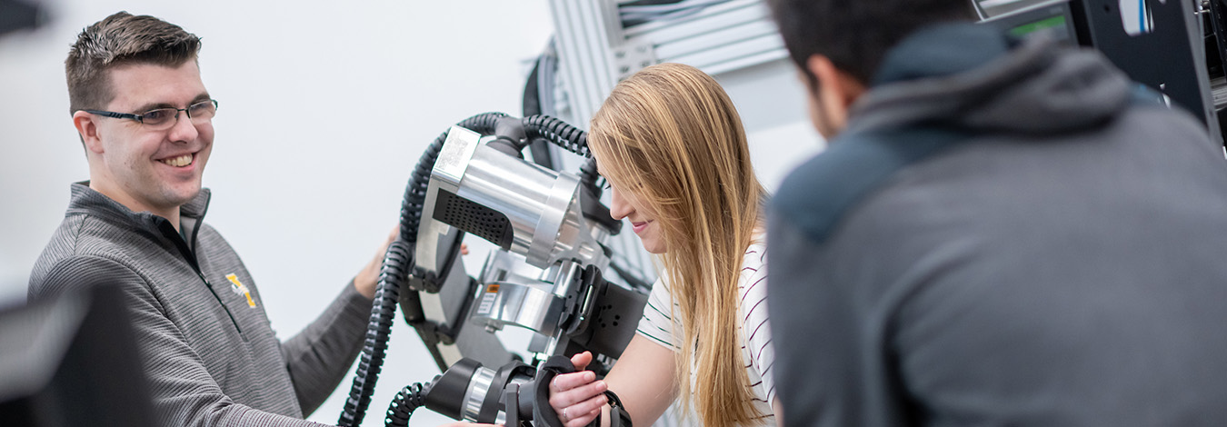 Students work with robotic devices used to develop better therapies for stroke patients.