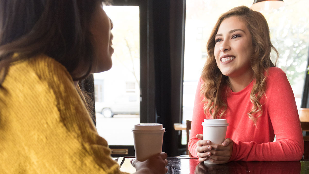 Two students talking over coffee