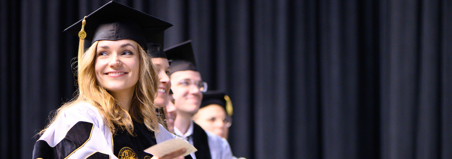 Students smile at the Commencement ceremony.
