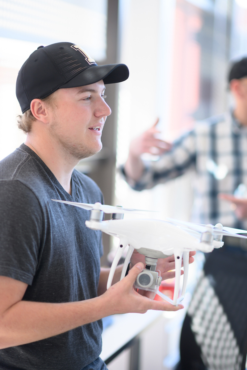 Dan Lauritzen holds a drone.