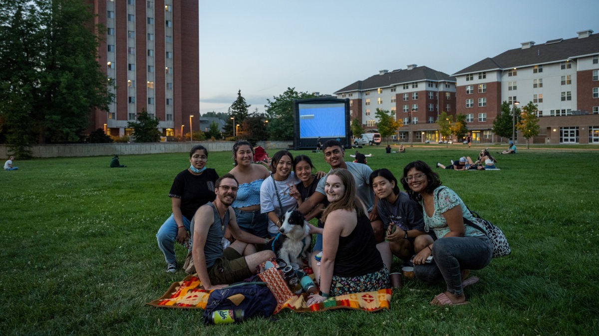 A group of students (and a dog) gathering together for Screen on the Green
