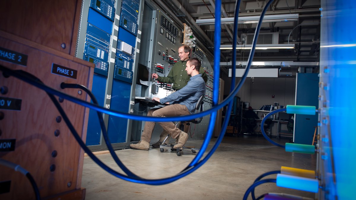 Brian Johnson and Mike West work in the electrical engineering lab to develop a system for measuring power generator parameters with support from SEL.