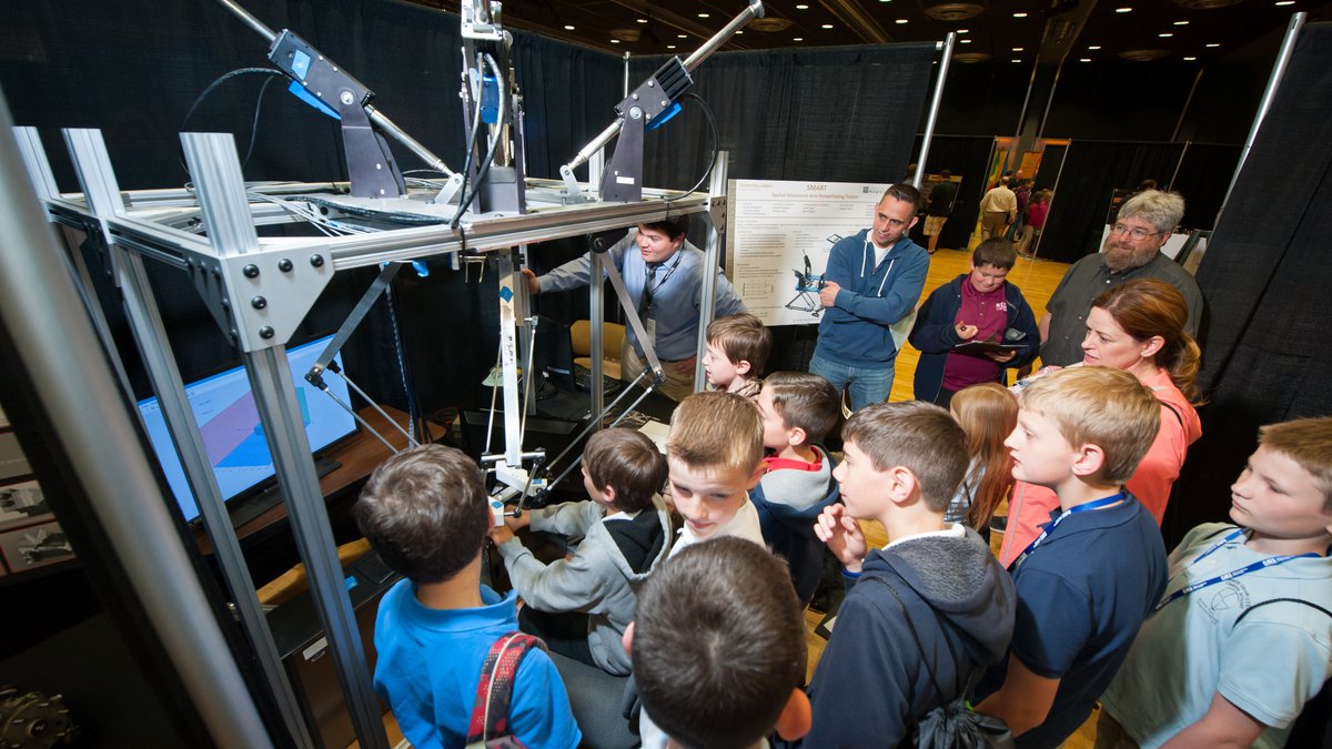 A group of young local students view a demo at the annual engineering expo.