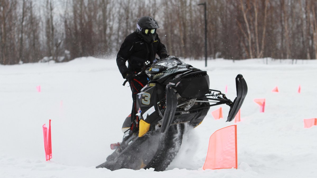 The college of engineering's clean snowmobile takes a jump off from a ramp. The college of engineering's clean snowmobile takes a jump off from a ramp.