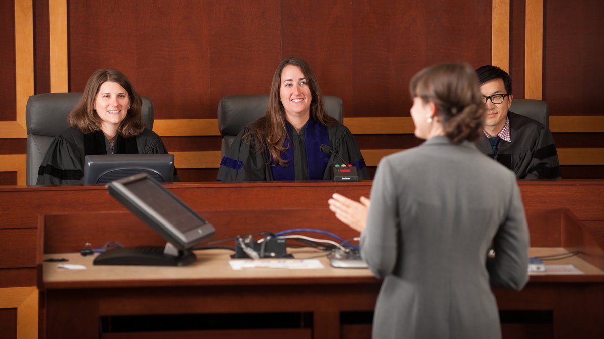 Law students participating in a mock court setting. Law students participating in a mock court setting.