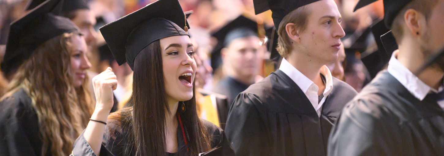 A Vandal graduate cheers as she lines up during commencement.
