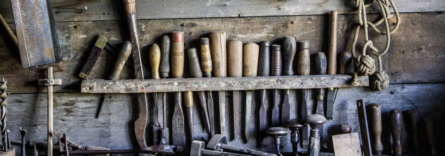A selection of tools with metal and wooden handles