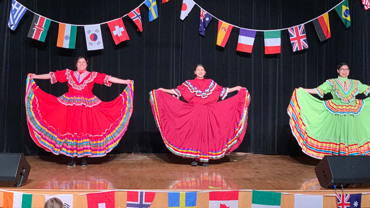 Three performers showcasing their culture at Cruise the World.