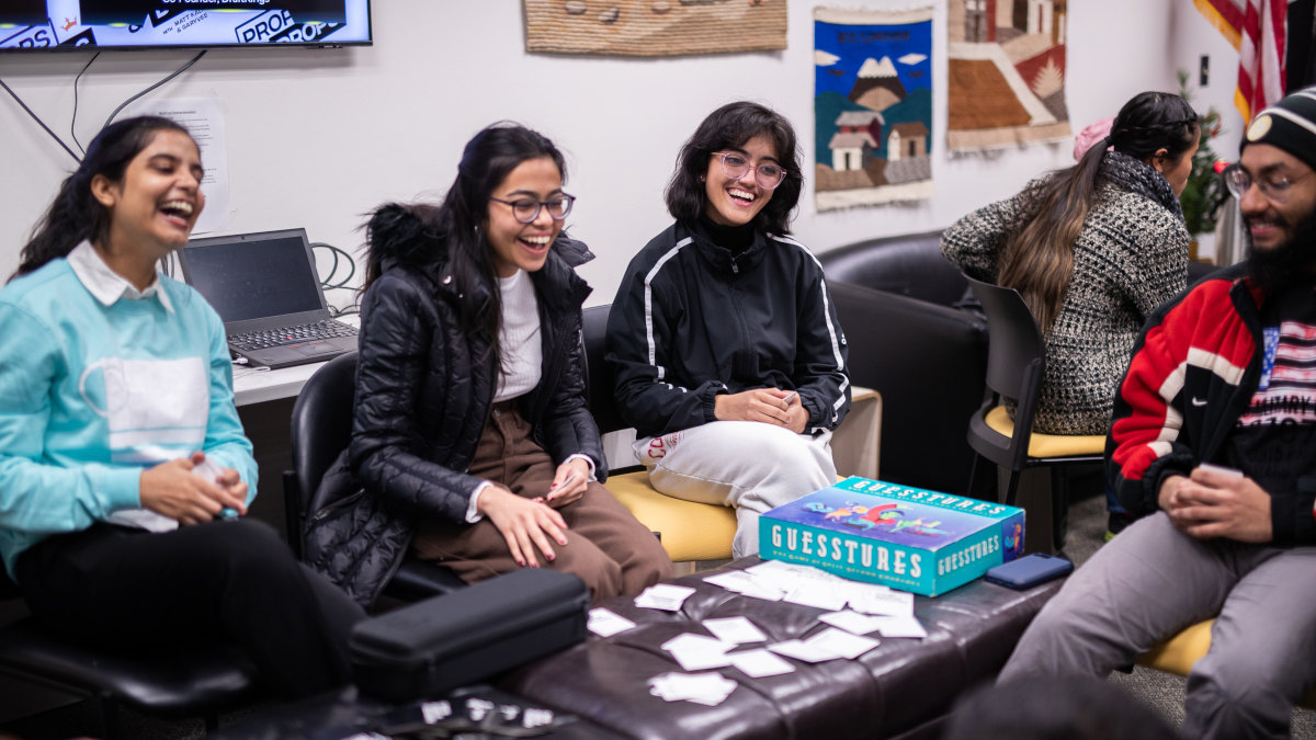 International students laughing while playing board games