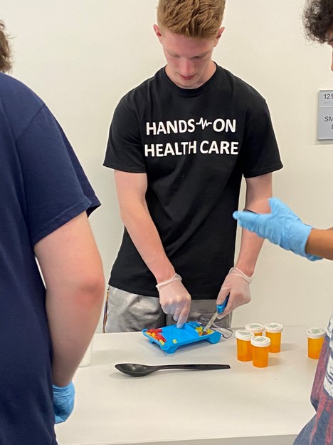 student working at hands on health care