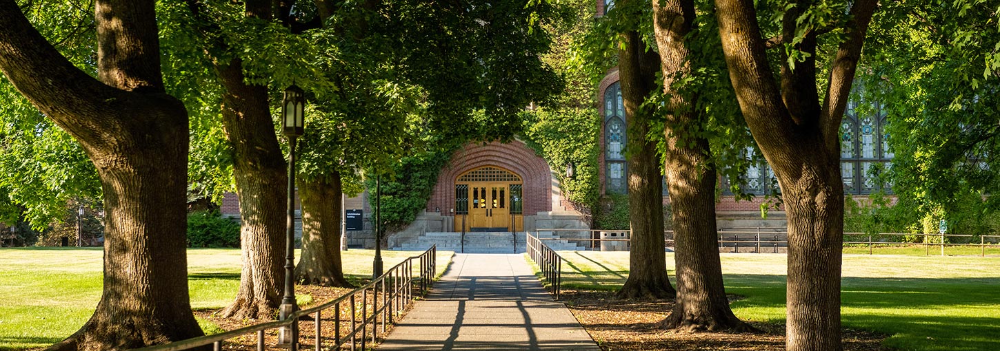 buena vibra college tour 2022 A path along Admin Lawn shaded by trees, leading to the north doors of the Administration Building.