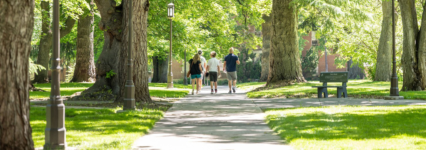 A group walks a path across Admin Lawn.