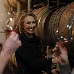 Owner Pam Walden smiles while engaging with two people tasting Willful Wine.