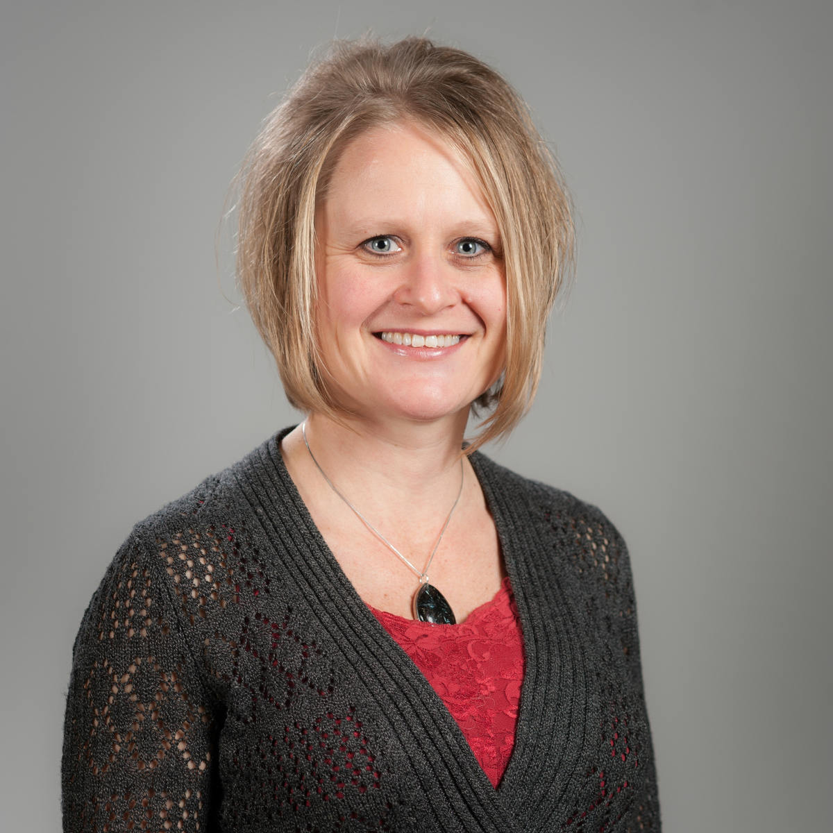Jodi Walker smiles in a photography studio