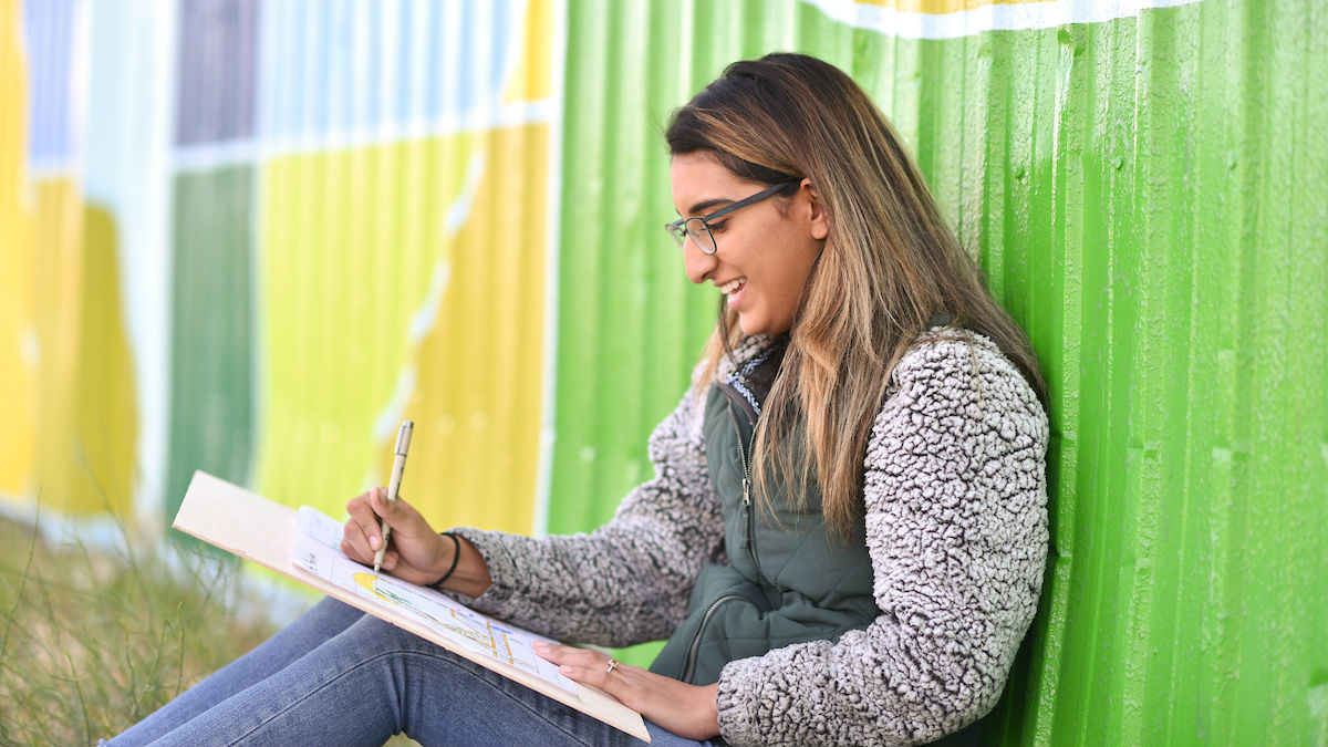 Yanira Saldana working on an architectural drawing