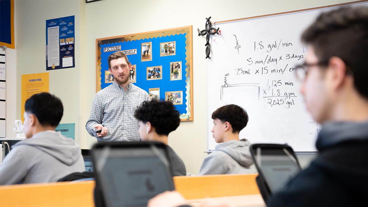 A person standing in front of a classroom.