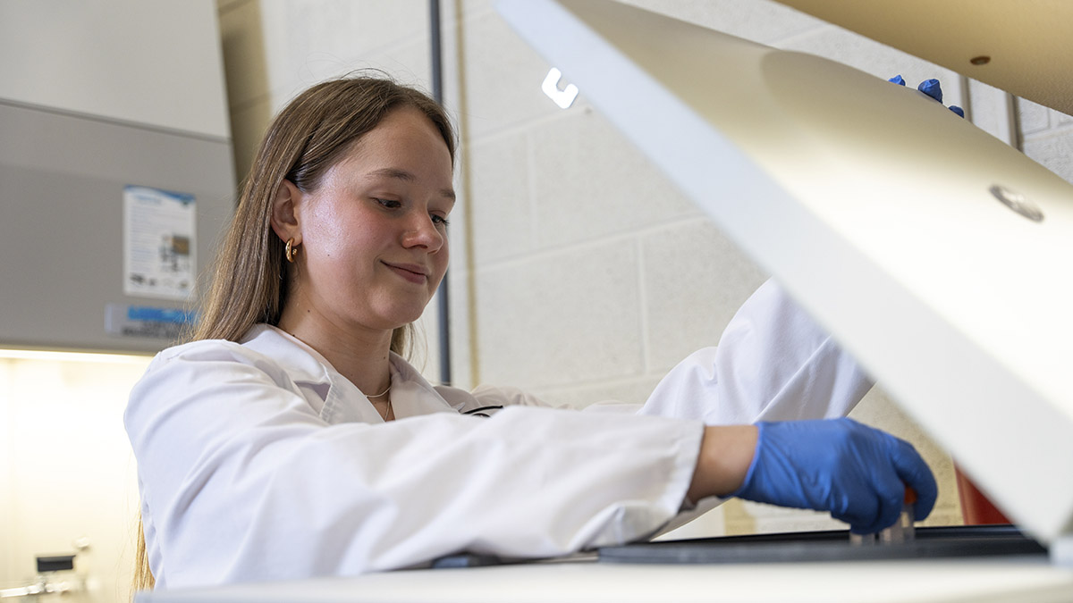 A woman scanning a sample in a lab.