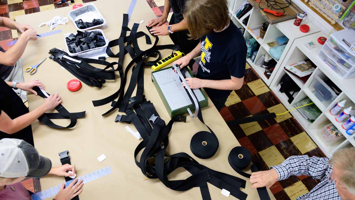 People on assembly line making belts