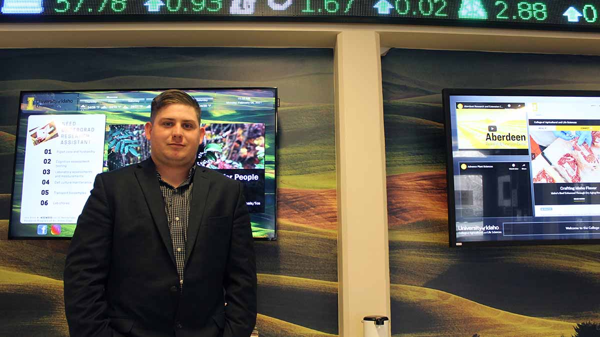 Man standing in front of display screens