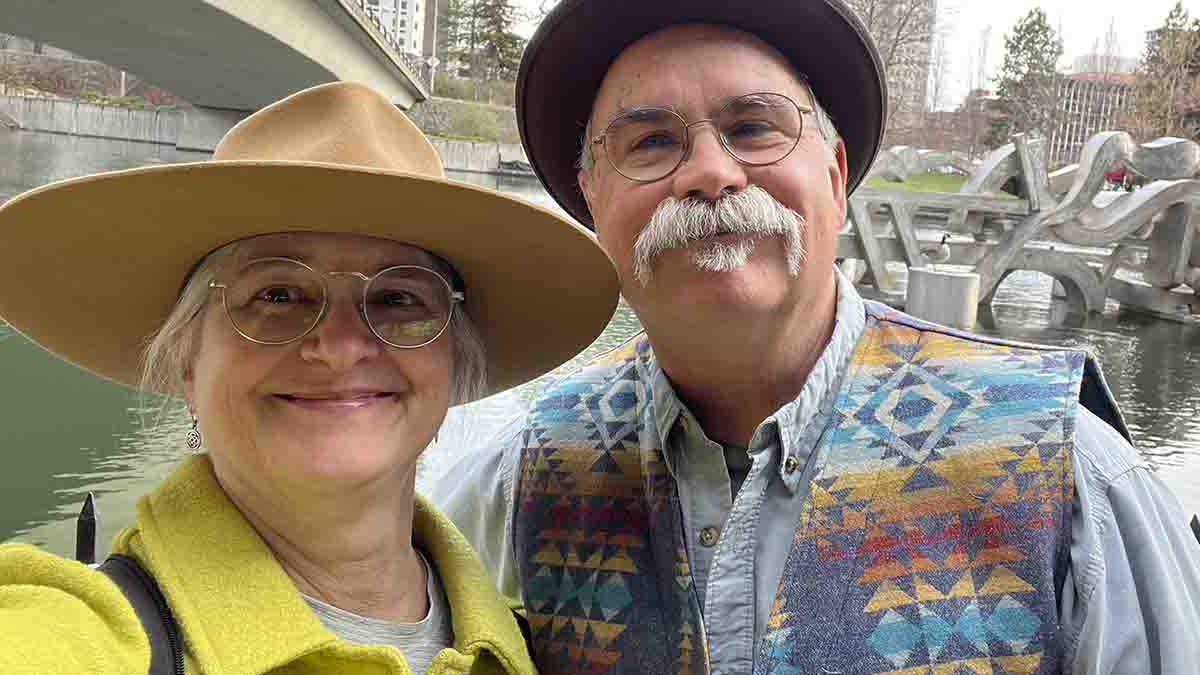 Selfie of a woman and man wearing hats.