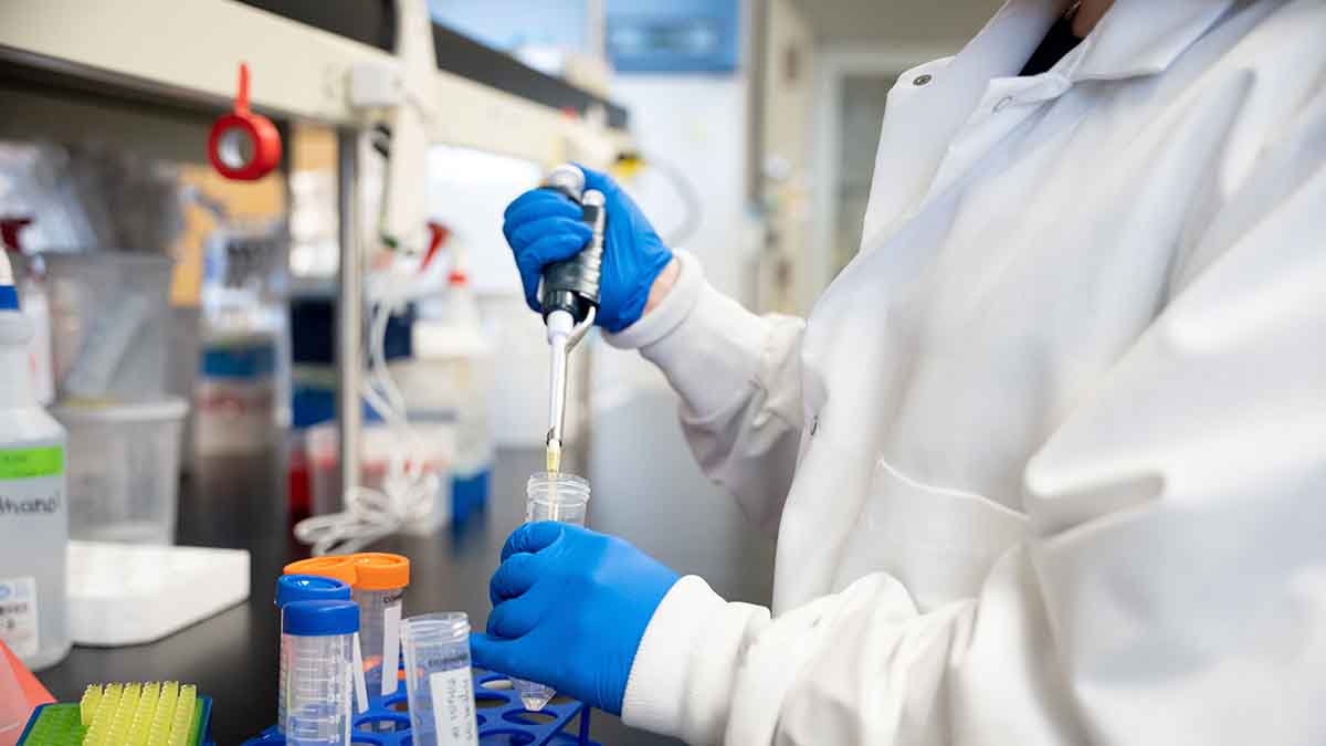 A person in a lab with test tubes.