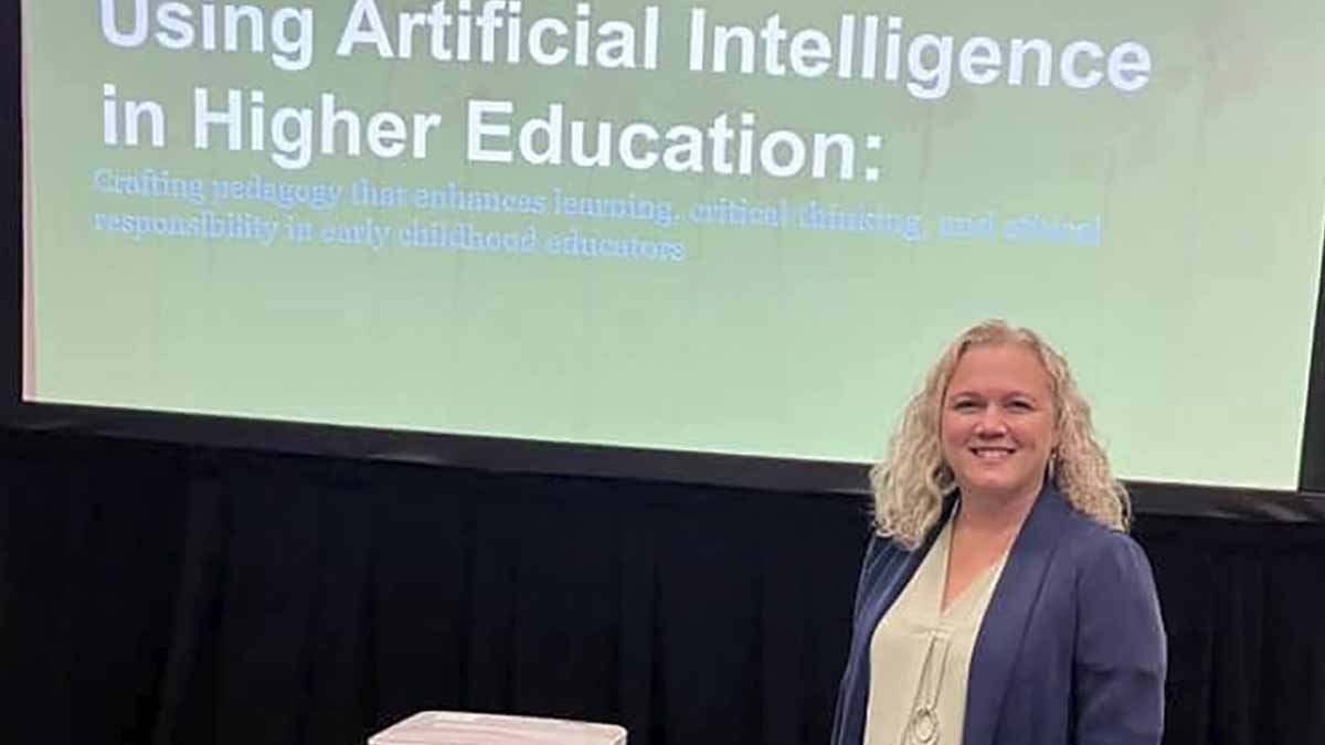 A woman standing in front of a presentation screen.
