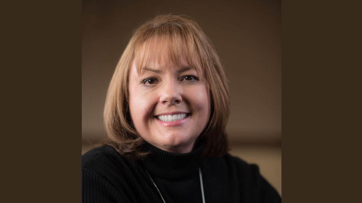 Portrait of a woman in a black sweater.