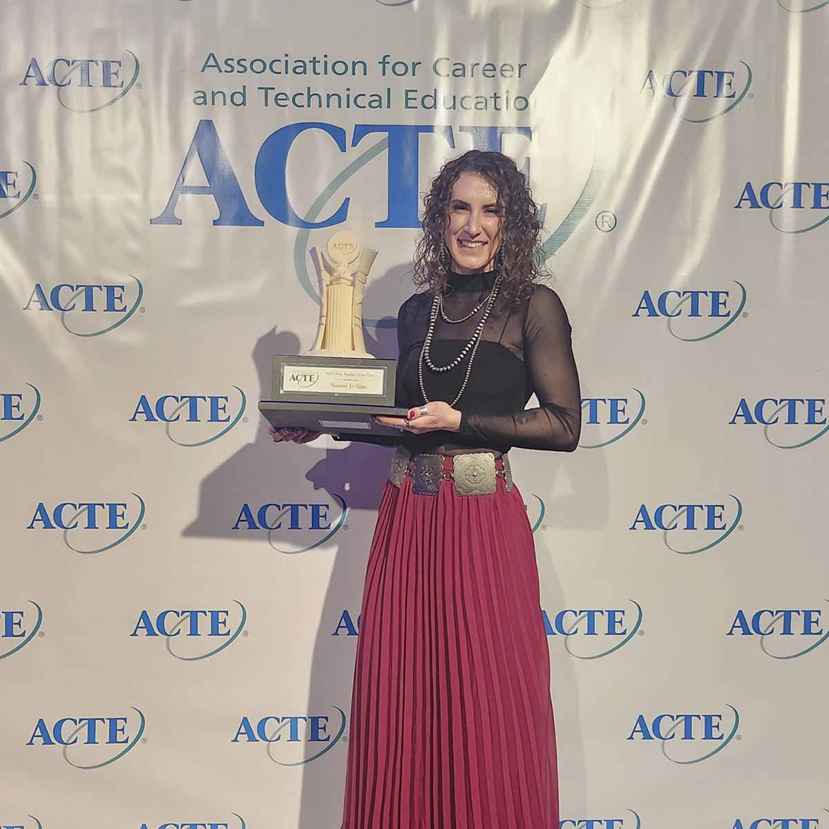 A woman holding an award.