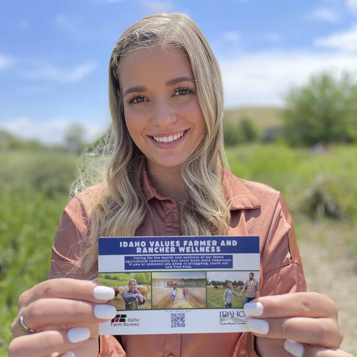 A woman holding up a card.