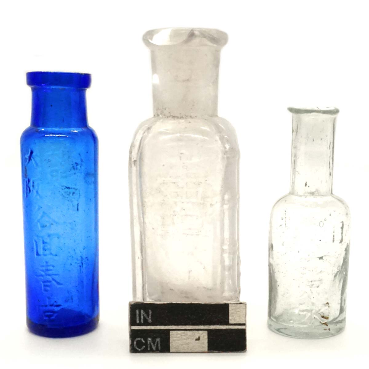 Medicine bottles; cobalt, amethyst, and aqua glass.