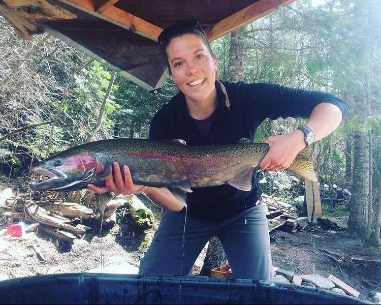 Kayla Brauer holding a steelhead fish