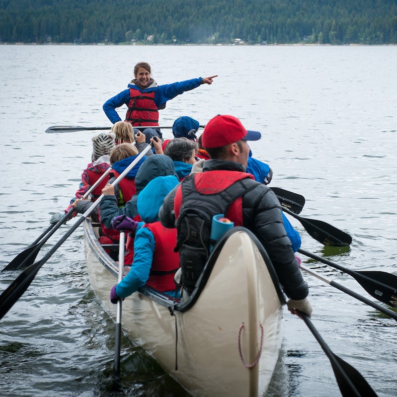 Students paddle a canoe.