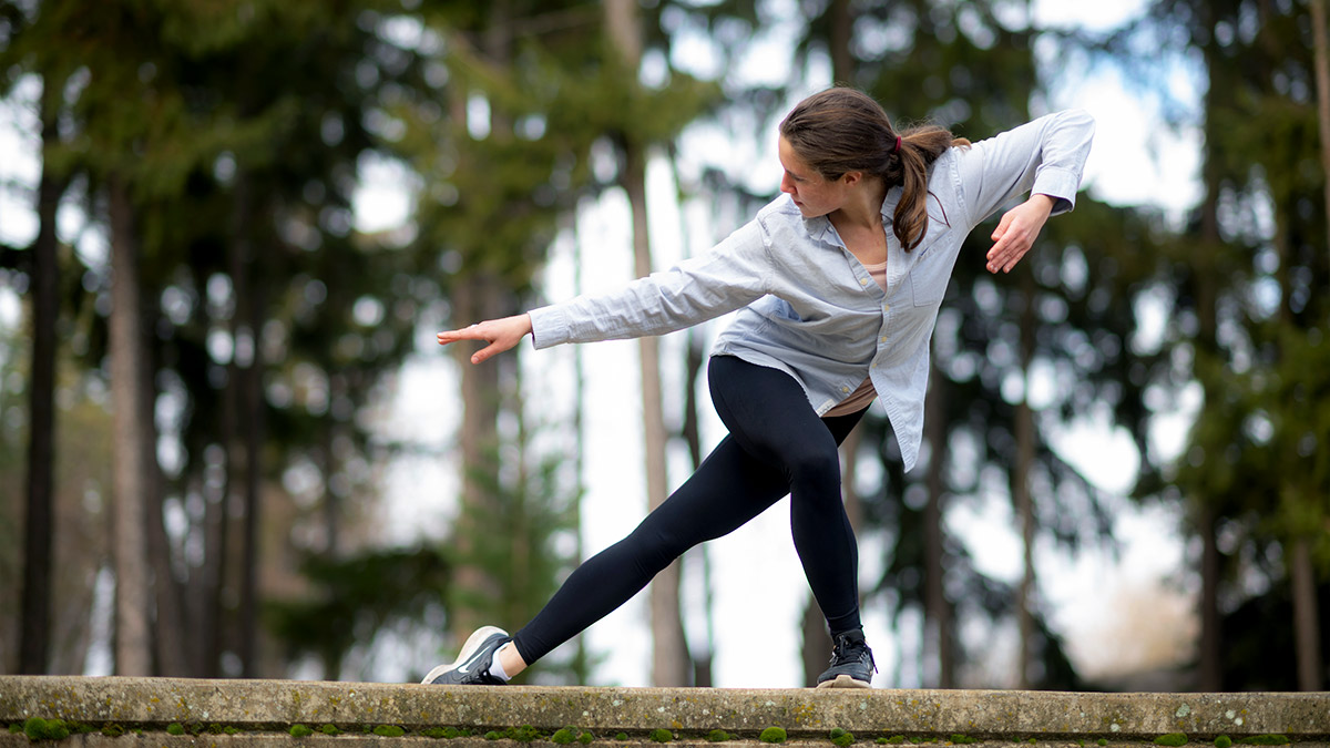 Two women dance on the steps of an outdoor amphitheater.