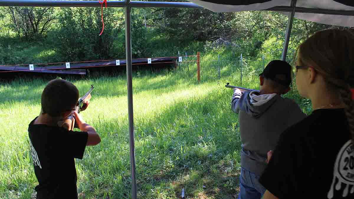 Boys learning how to shoot.