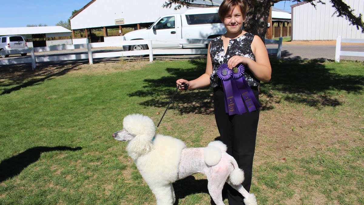 A girl showing her dog