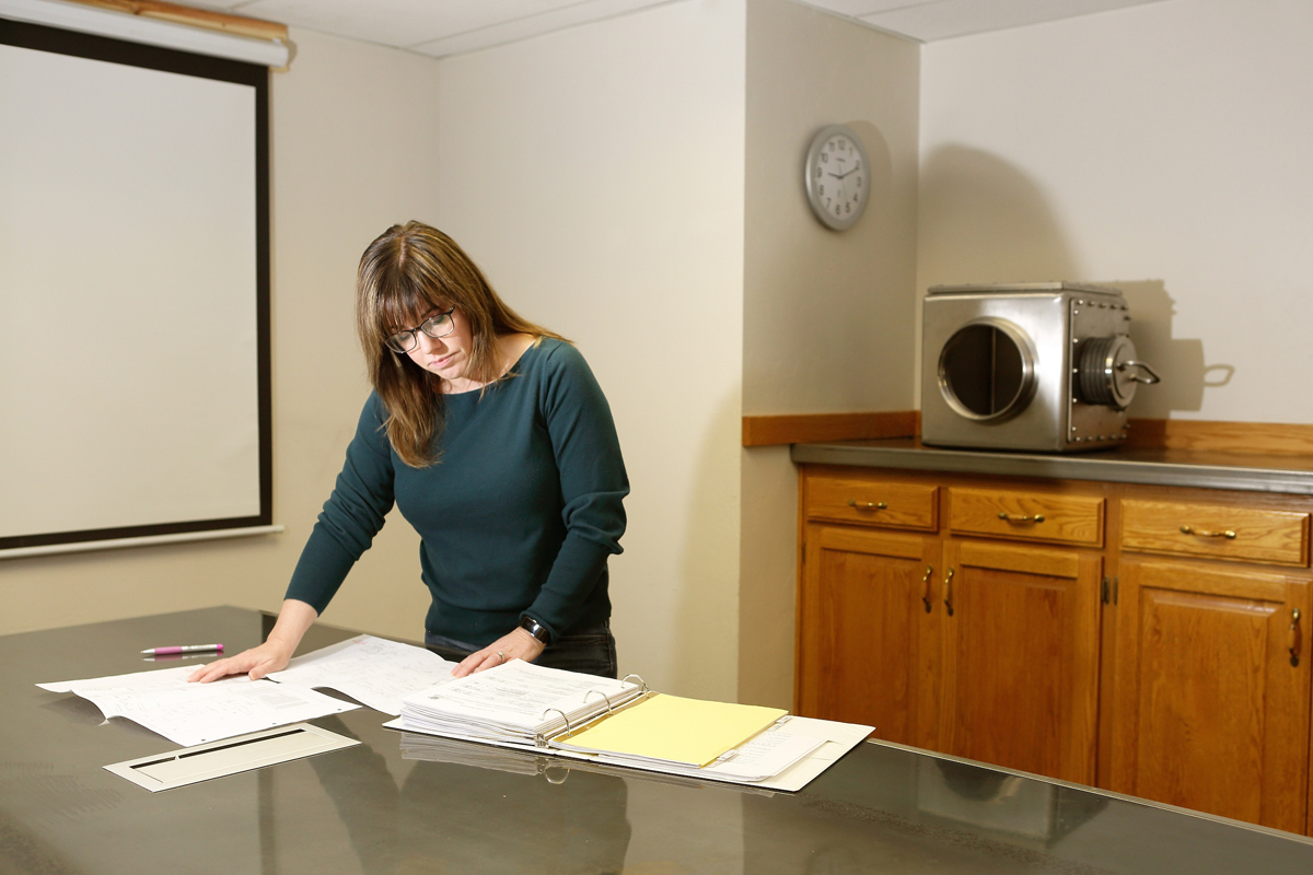 Rebecca McClellan reviews contracts in the office at Diversified Metal Products in Idaho Falls.