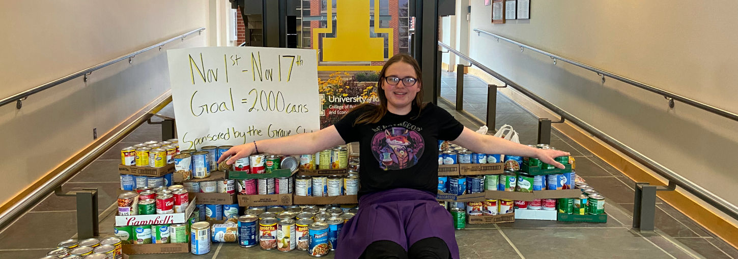 University of Idaho student, Zoe Evans stacks cans of food she purchased for a donation.