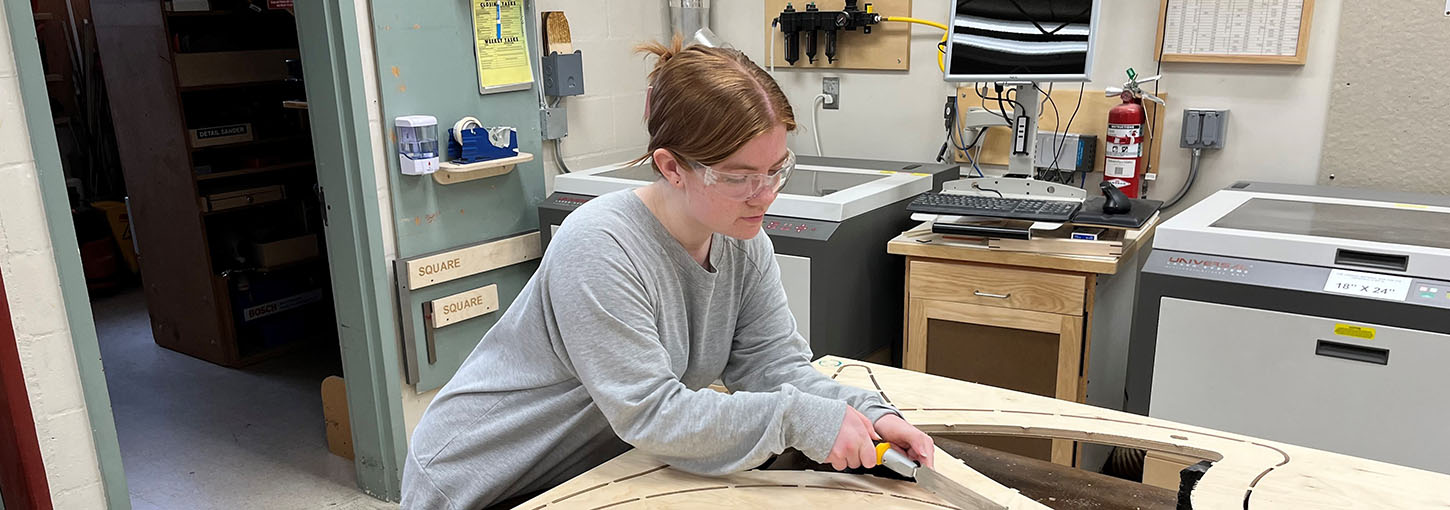 Woman working in wood shop.