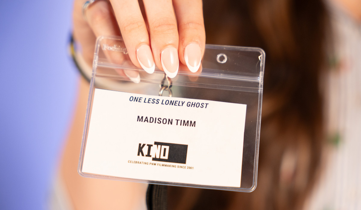 hand holds an event pass that reads One Less Lonely Ghost Madison Timm