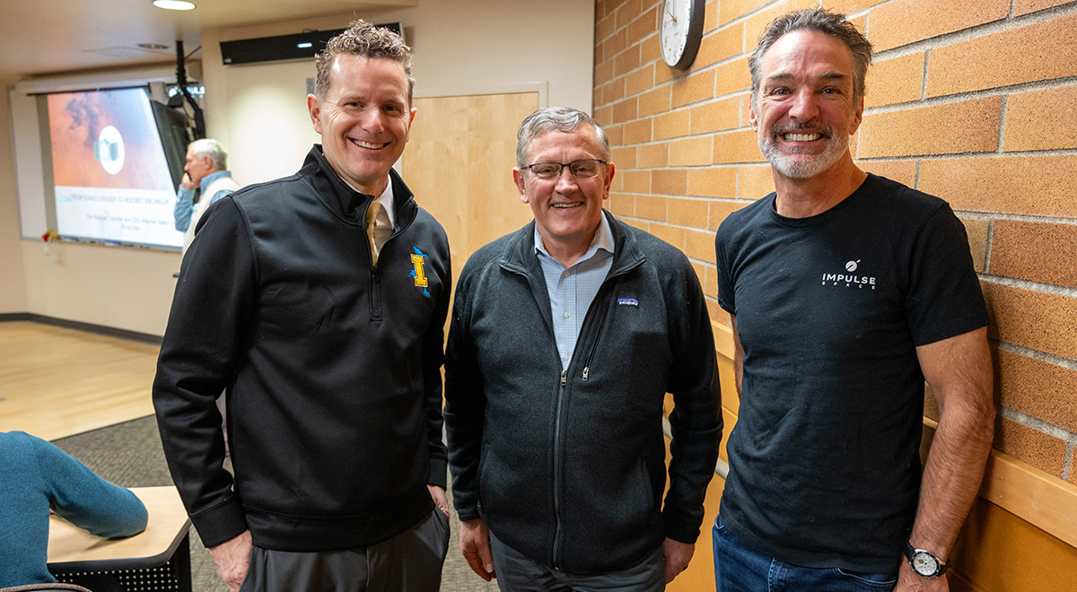 Tom Mueller poses with two campus leaders.