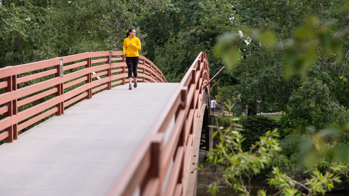 A person running across a bridge.