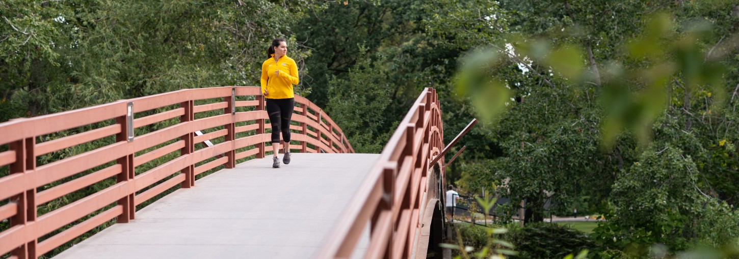 A person running across a bridge.