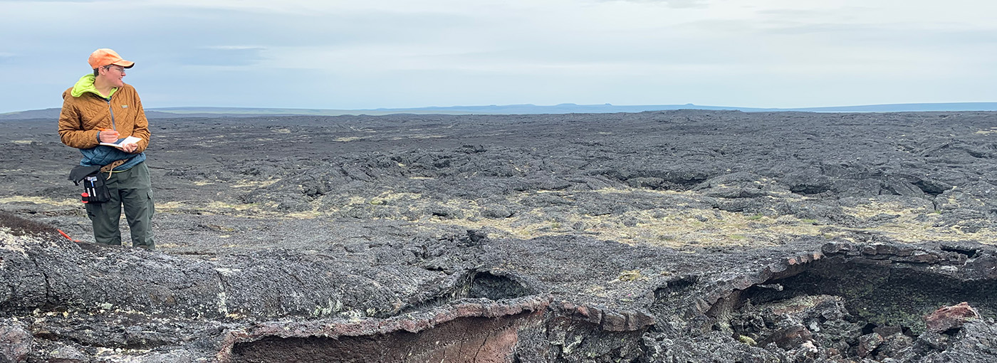 Erika Rader on a rocky landscape in Alaska.