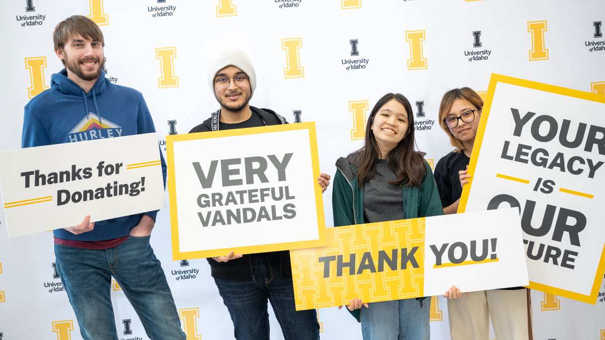 Students holding signs that read thanks messages to donors