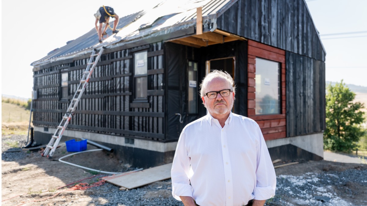 Mark Engberg standing in front of house under construction.